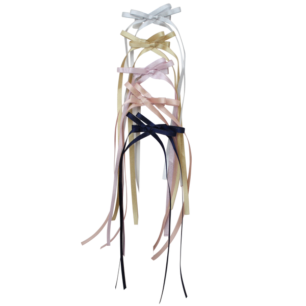 Skinny satin headbands with long ribbon bows in white, cream, blush, pink, and navy